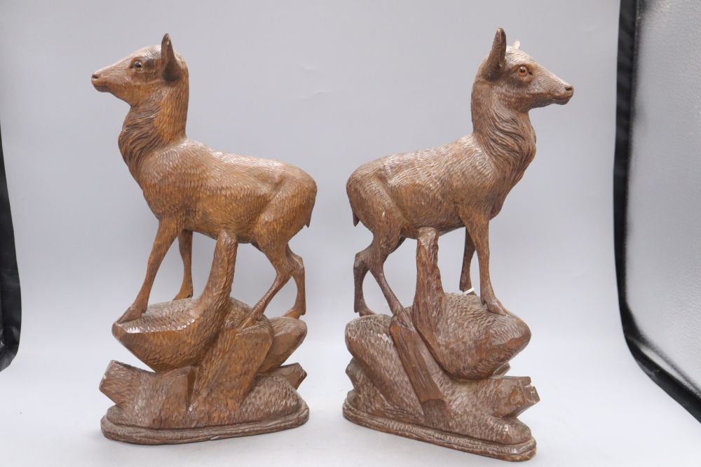 A pair of Black Forest carved deer, c.1860, height 34cm